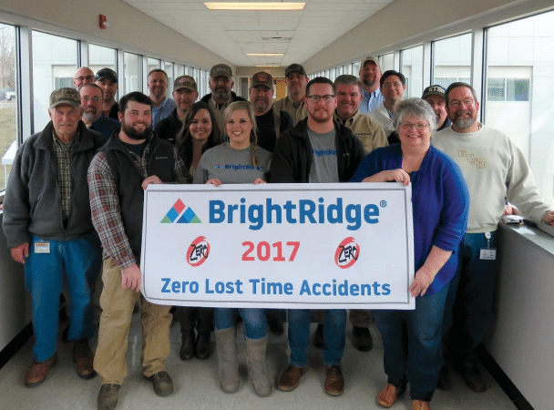 A group of people stands in a hallway, holding a banner that reads "BrightRidge 2017, Zero Lost Time Accidents.