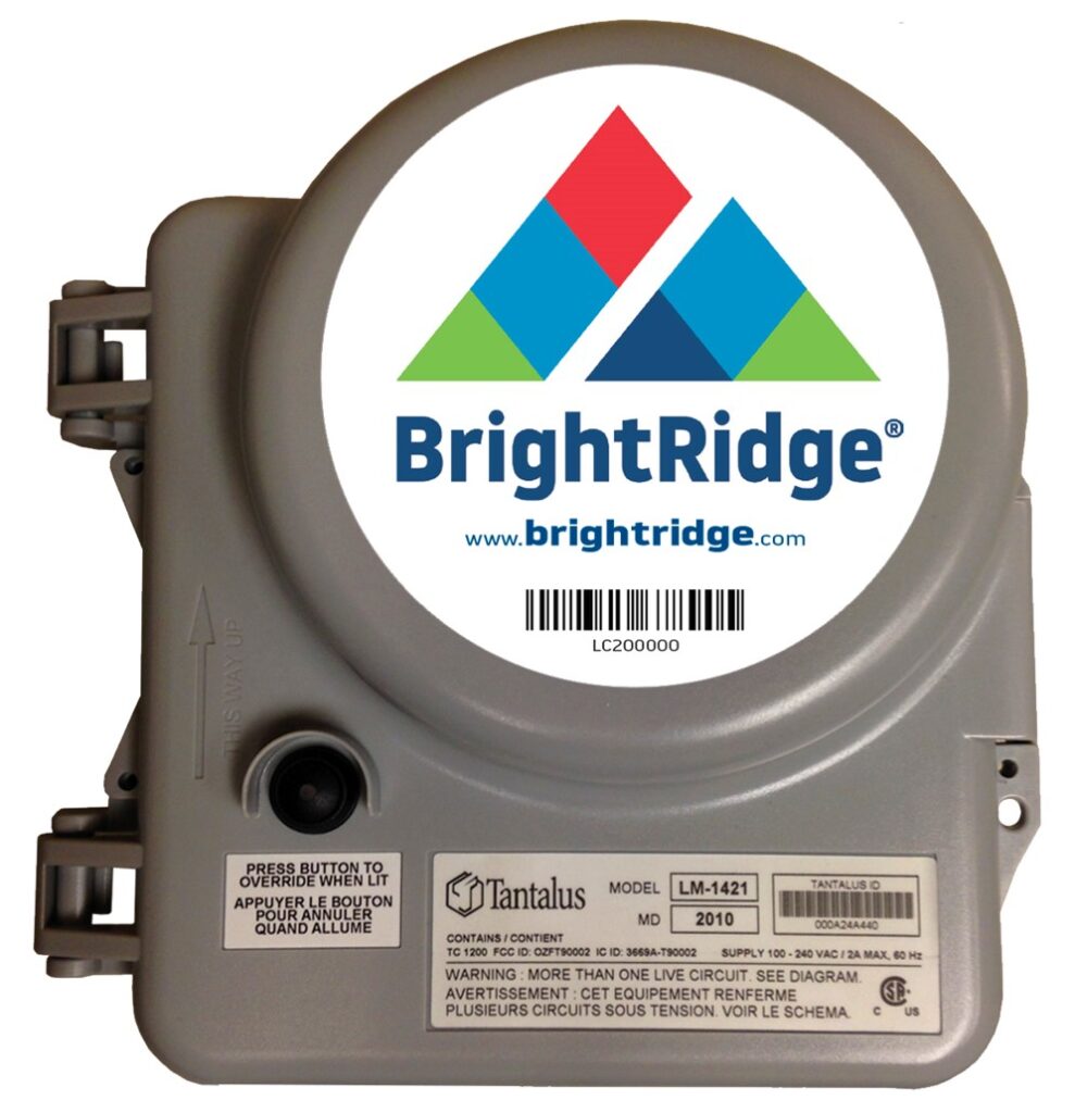 Electric utility meter labelled "BrightRidge" with the model number LM-1421 by Tantalus, featuring a power button and a warning in multiple languages.