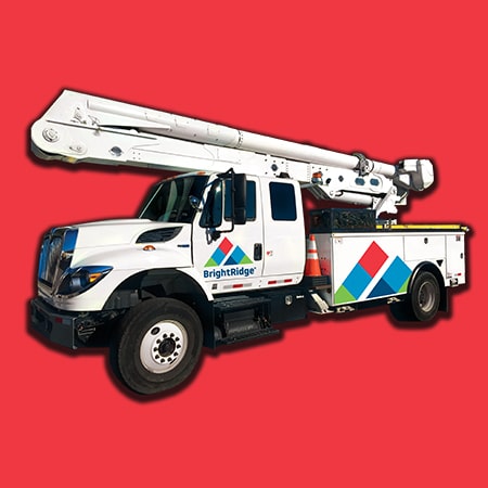 A utility service truck labeled "BrightRidge" with an extended boom lift against a red background.